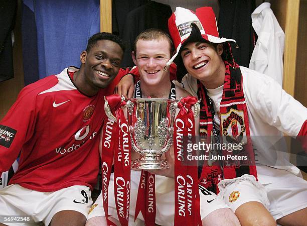 Louis Saha, Wayne Rooney and Cristiano Ronaldo of Manchester United pose with the Carling Cup trophy in the dressing room after the Carling Cup Final...