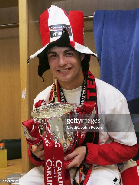 Cristiano Ronaldo of Manchester United poses with the Carling Cup trophy in the dressing room after the Carling Cup Final match between Manchester...