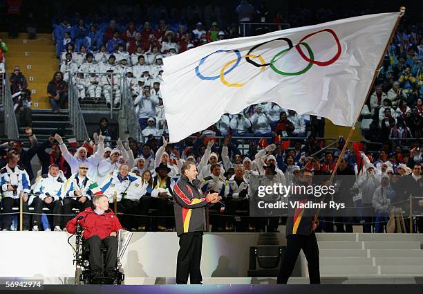Sergio Chiamparino, the mayor of Turin carries the Olympic flag to hand over to Sam Sullivan, the mayor of Vancouver during the Closing Ceremony of...