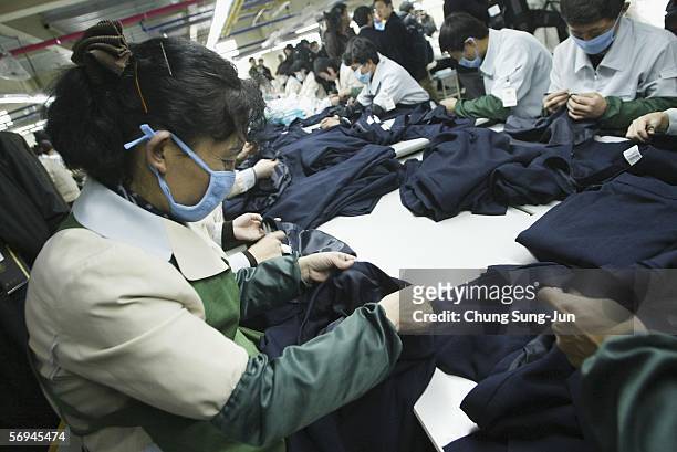 North Korean women work at the assembly line of the factory of textile company Shinwon Inc. At the Kaesong industrial complex on February 27, 2006 in...