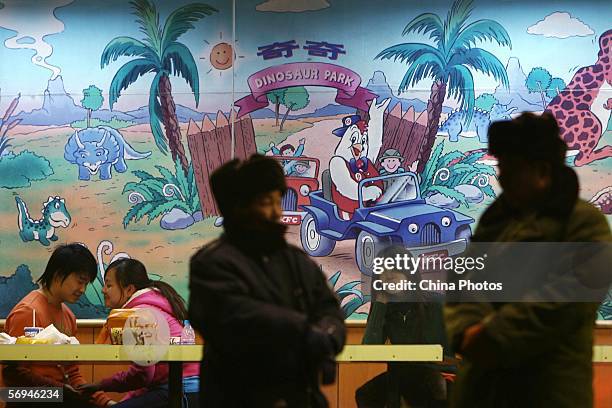Customers dine at a Kentucky Fried Chicken restaurant as security guards stand by February 27, 2006 in Beijing, China. Chinese Agriculture Minister...