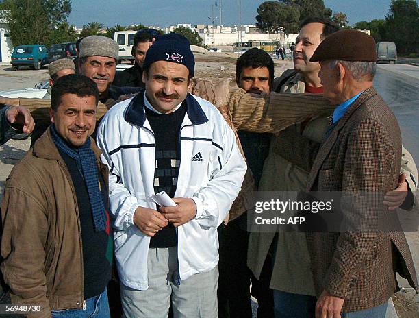 Tunisian teacher Ridha Belhaj poses with relatives after being released in front of the police department in Manouba 27 February 2006 near Tunis....