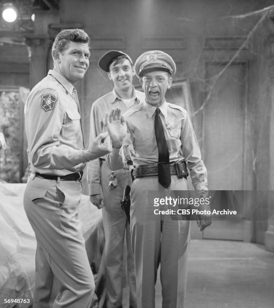 American actor Don Knotts waves to the camera while actor Andy Griffith clenches his fist and actor Jim Nabors smiles while on a break filming...