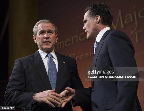 Washington, UNITED STATES: US President George W Bush walks to the lectern after shaking hands with Mitt Romney, Governor of Massachusetts, before...