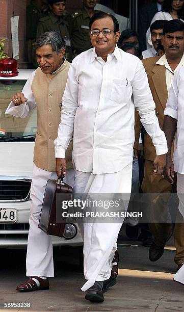 Indian Finance Minister P. Chidambaram comes out of the finance ministry on his way to the National Parliament where he was to present the...