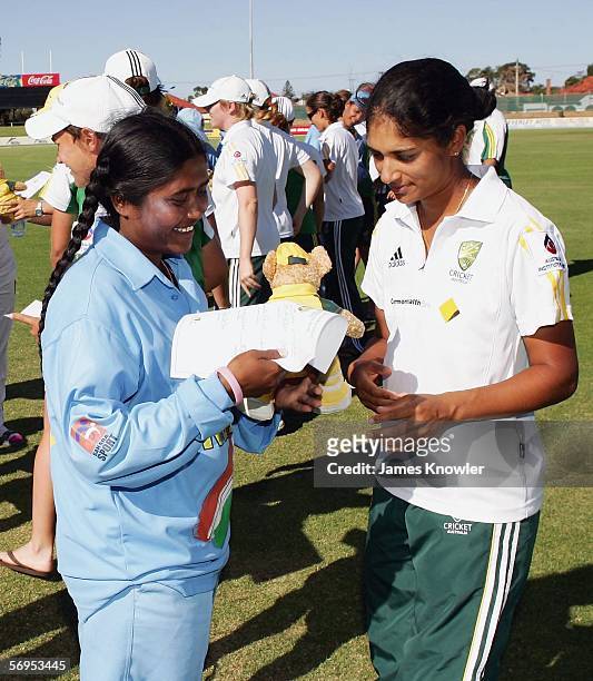 Lisa Sthalekar of Australia presents Neetu David of India with a Kangaroo toy after the third Women's International One Day match between Australia...