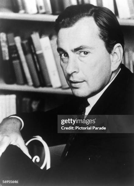 American novelist, playwright, and essayist Gore Vidal poses for a portrait in front of a bookcase, 1969.