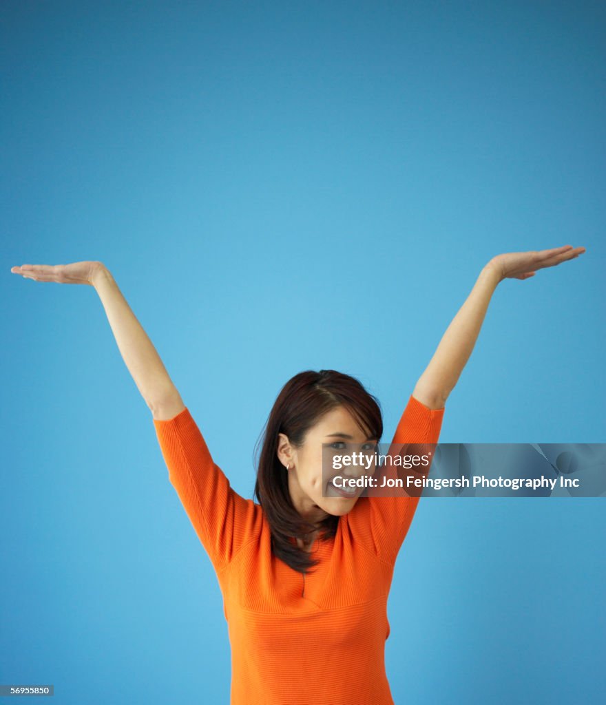 Young woman with arms raised