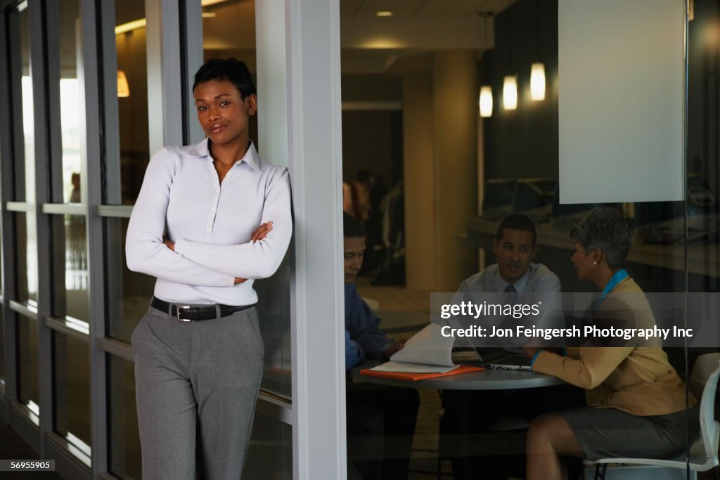 Smiling woman with colleagues in background