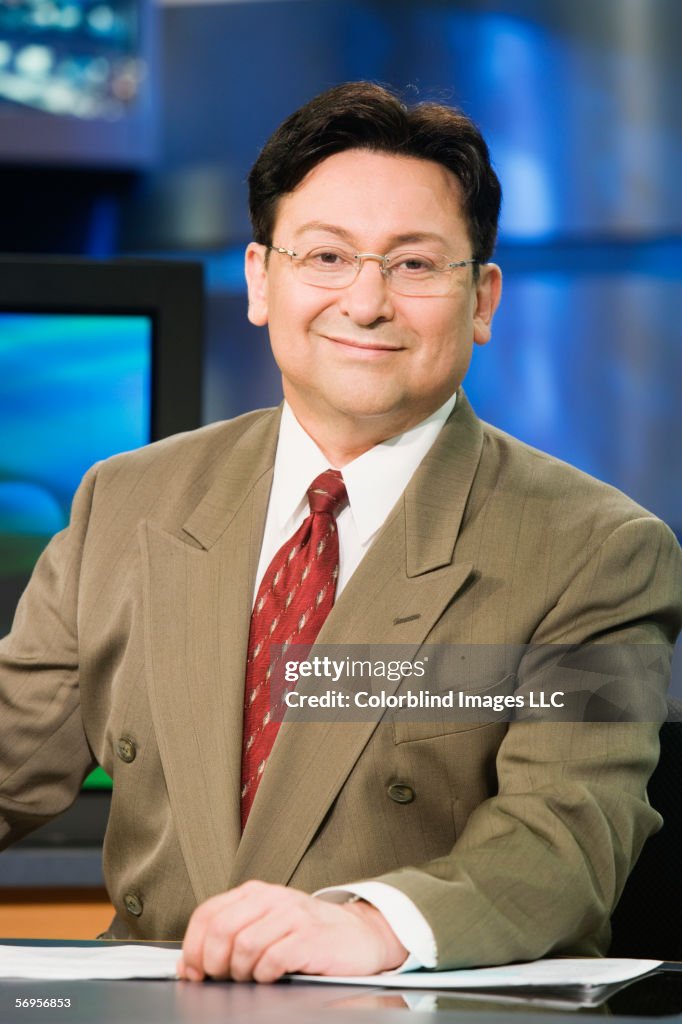 Portrait of male anchor in newsroom