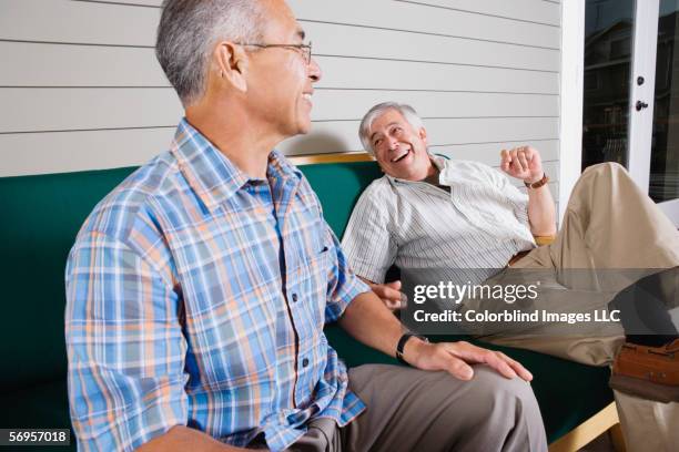 two elderly men sitting and laughing - old brother stock pictures, royalty-free photos & images