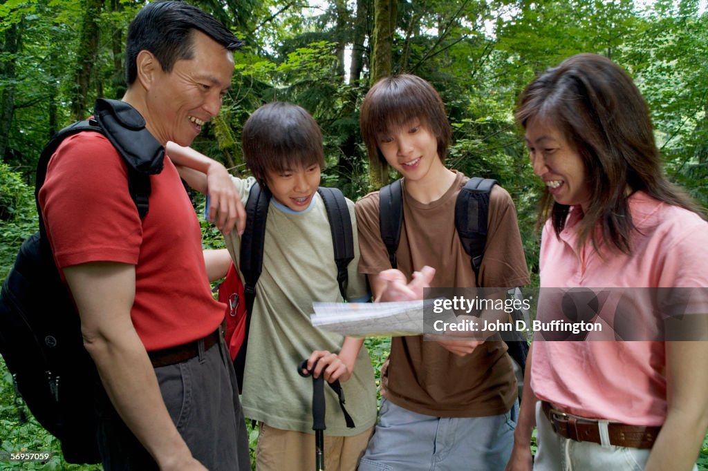 Family checking map while hiking