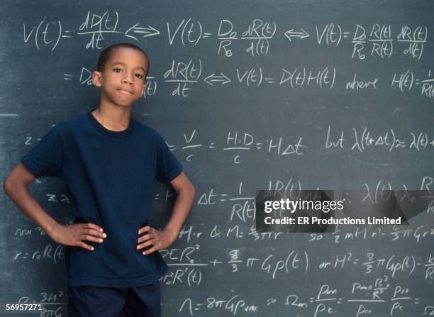 portrait of boy standing in front of chalkboard - genius fotografías e imágenes de stock