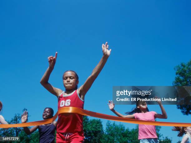 children crossing finish line in race - champions day three fotografías e imágenes de stock