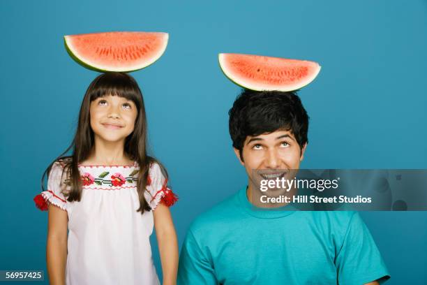 girl and young man balancing watermelon slices - portrait solid stock pictures, royalty-free photos & images