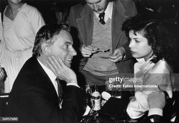 American novelist, playwright, and essayist Gore Vidal and actress Bianca Jagger sit at a table during a Tanya Tucker show at the Roxy, Los Angeles,...