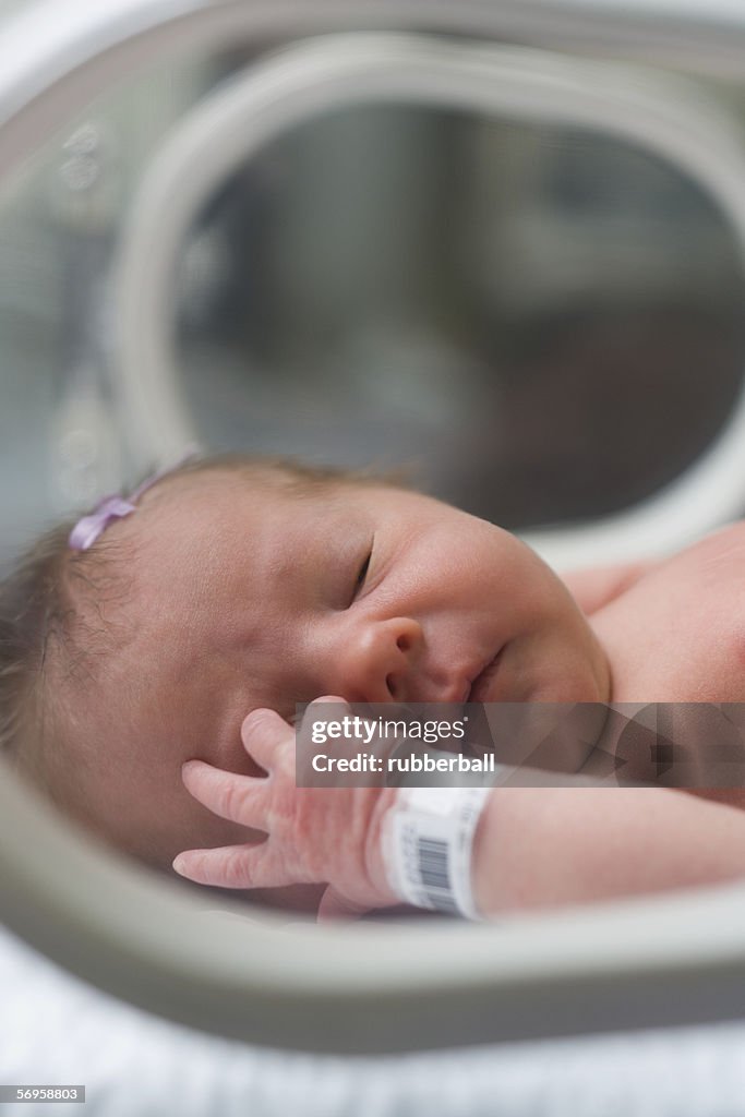 Newborn baby boy in an incubator