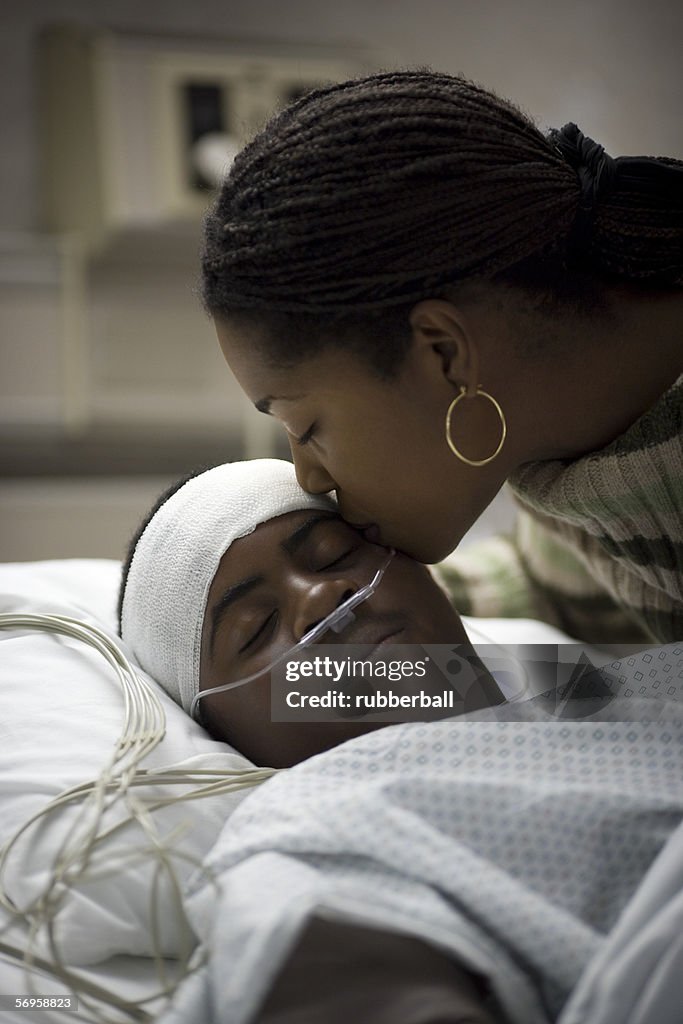 Close-up of a mother kissing her son