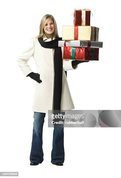 portrait of a young woman holding gifts - coat imagens e fotografias de stock