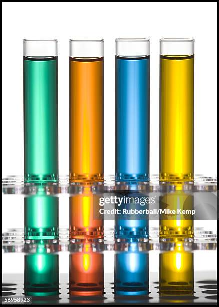 close-up of four test tubes on a test tube rack - reageerbuisrek stockfoto's en -beelden