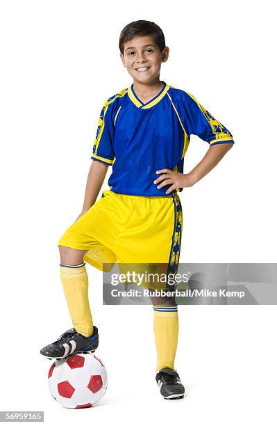 portrait of a boy resting his foot on a soccer ball - kids white socks stock pictures, royalty-free photos & images