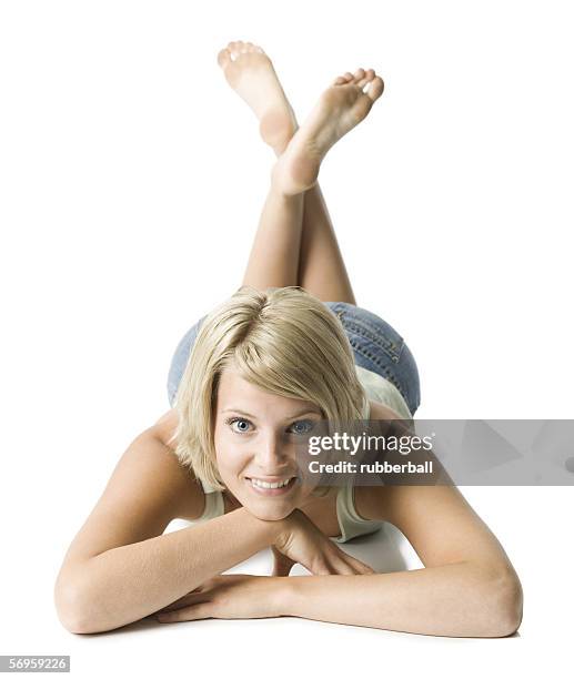 portrait of a young woman lying on the floor - bottom of feet foto e immagini stock