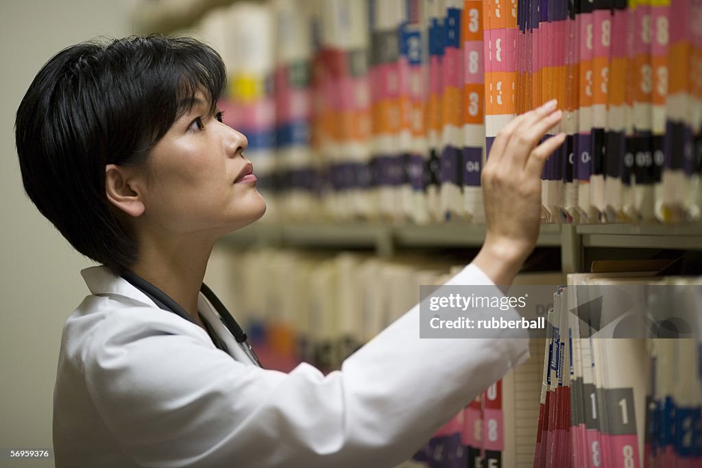 Doctor File Work Profile Of A Female Doctor Looking For A File In The Medical Records ...