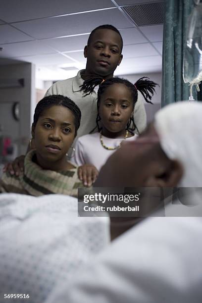 parents and their daughter looking at a teenage boy in the hospital - father confident secure reliable leader stock pictures, royalty-free photos & images