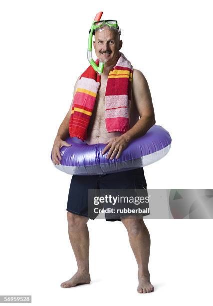 portrait of a man standing with an inflatable ring around his waist - glory tube 個照片及圖片檔
