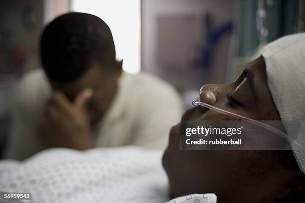 father sitting beside his son lying on a hospital bed - father confident secure reliable leader stock pictures, royalty-free photos & images