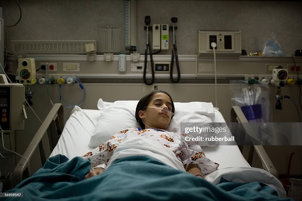 High angle view of a female patient sleeping on a hospital bed