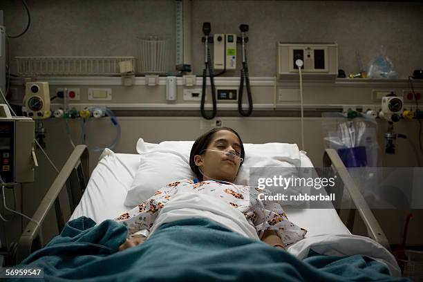 high angle view of a female patient sleeping on a hospital bed - medvetslös bildbanksfoton och bilder