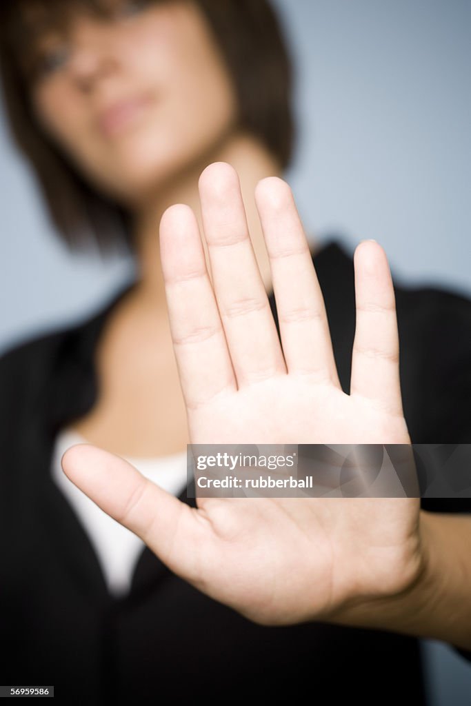 Teenage girl making a stop gesture