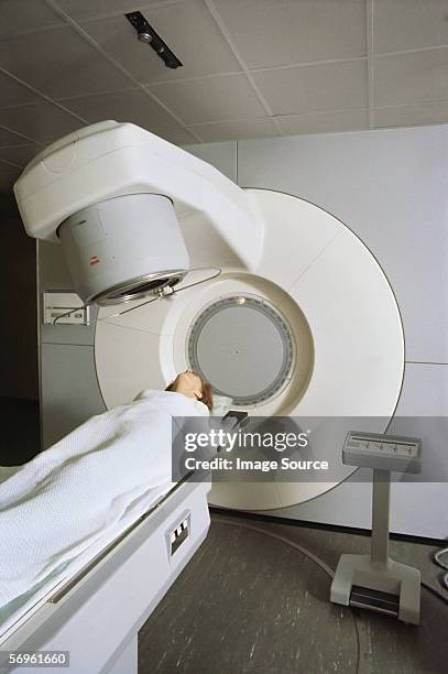 woman receiving radiotherapy - particle accelerator stock pictures, royalty-free photos & images