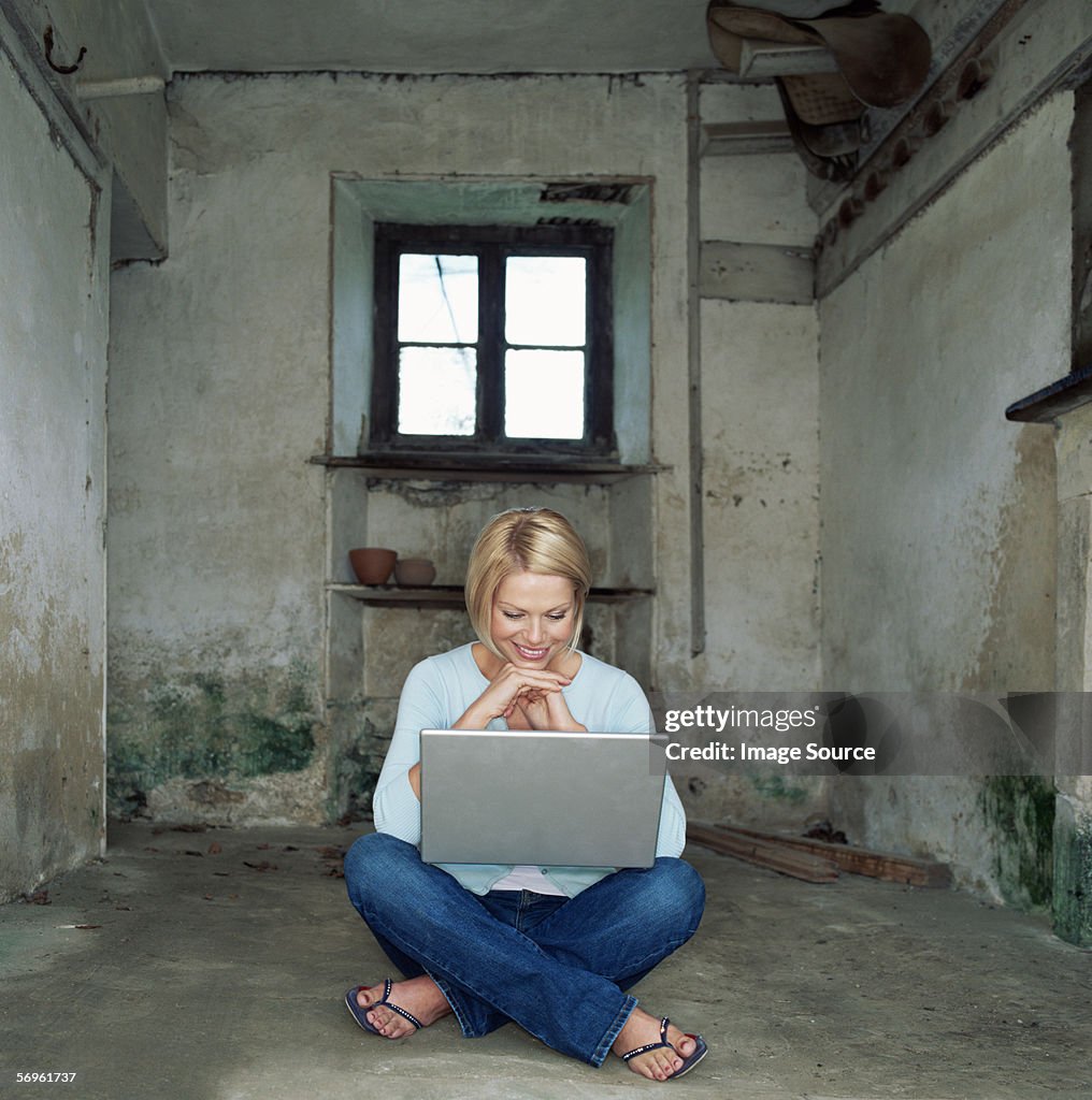 Woman using laptop in basement