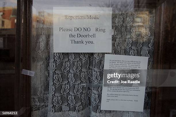 Sign telling the media not to ring the doorbell is taped to the window of the door to the childhood home of Boston graduate student Imette St....