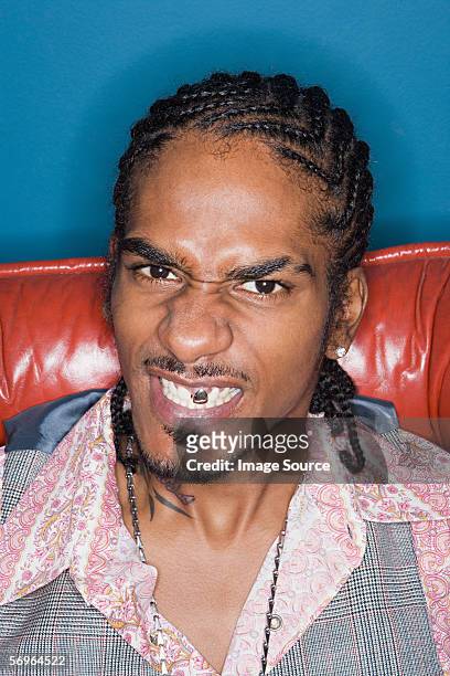 grimacing man displaying gold tooth - cornrows stock pictures, royalty-free photos & images