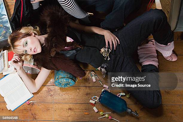 young woman lying on floor at party - series finale party stockfoto's en -beelden