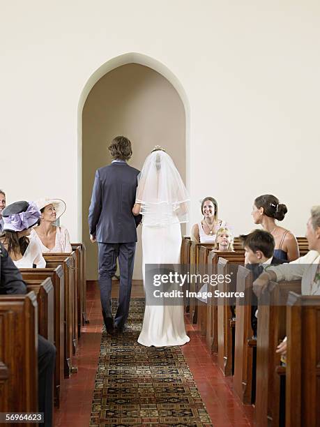 bride and groom in church - church wedding aisle stock pictures, royalty-free photos & images