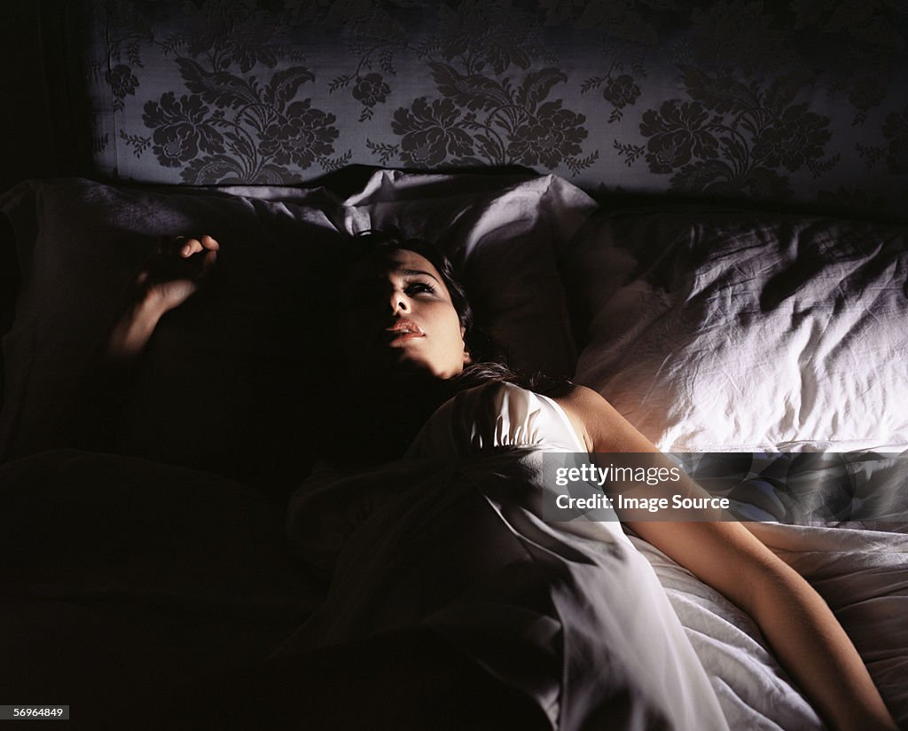 Woman lying in bed