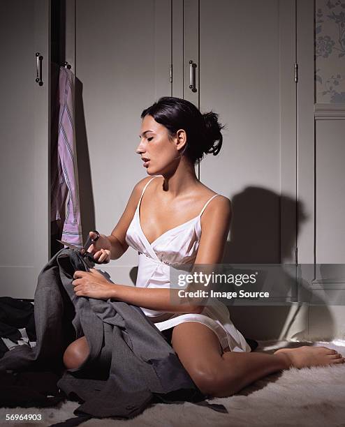 woman cutting up mans clothes - avengers stock pictures, royalty-free photos & images