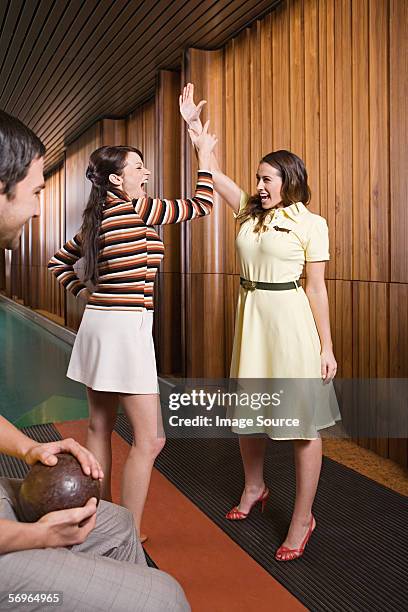 friends at a bowling alley - bowling alley stock pictures, royalty-free photos & images