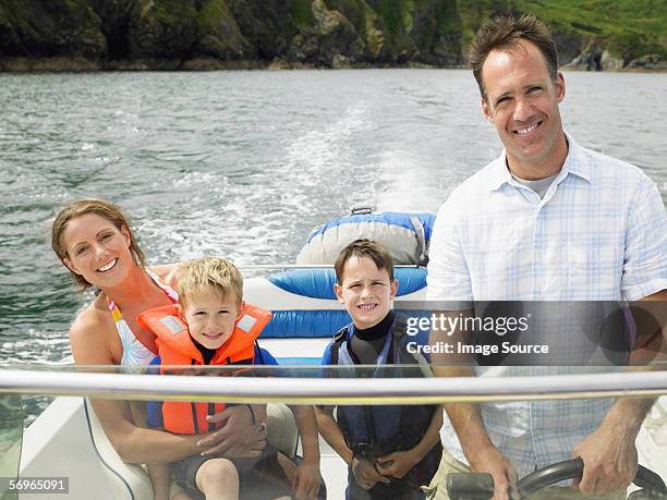 family on boat - boy river looking at camera stock pictures, royalty-free photos & images