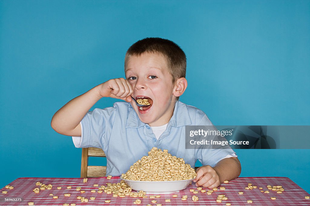 Boy with lots of breakfast cereal