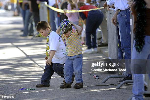 Children gather beads in the street as they participate in Biloxi's annual Mardi Gras parade on Fat Tuesday February 28, 2006 in Biloxi, Mississippi....