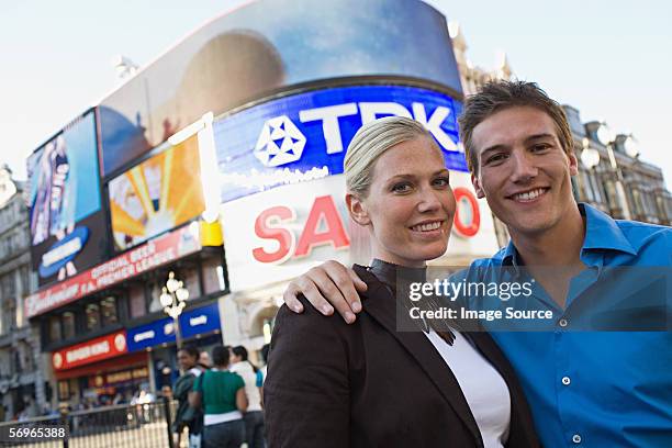 couple in piccadilly circus - london theatre stock pictures, royalty-free photos & images