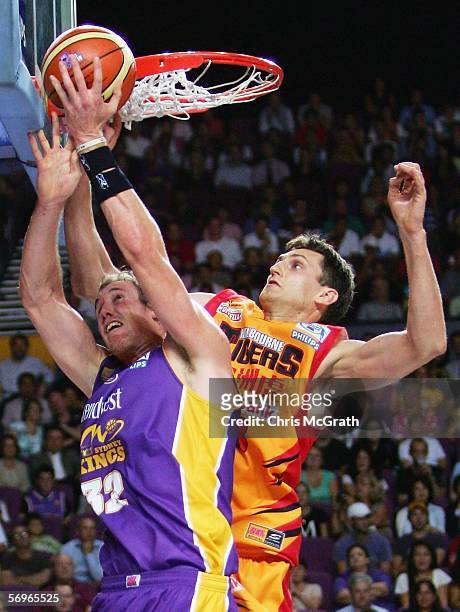 Chris Anstey of the Tigers rejects a shot by Ben Knight of the Kings during game three of the NBL grand final series between the Sydney Kings and the...