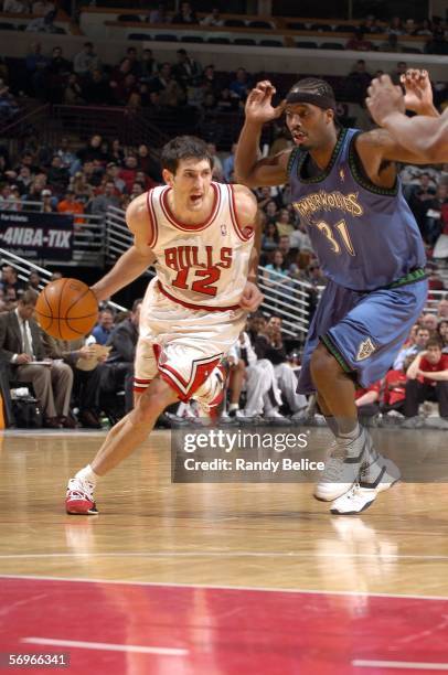 Kirk Hinrich of the Chicago Bulls moves the ball past Ricky Davis of the Minnesota Timberwolves on February 28, 2006 at the United Center in Chicago,...