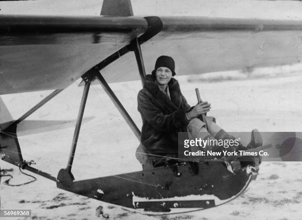 American aviator Amelia Earhart sits at the controls of an experimental glider before a flight at the Scripps estate 'Wildwood Farms,' Lake Orion,...