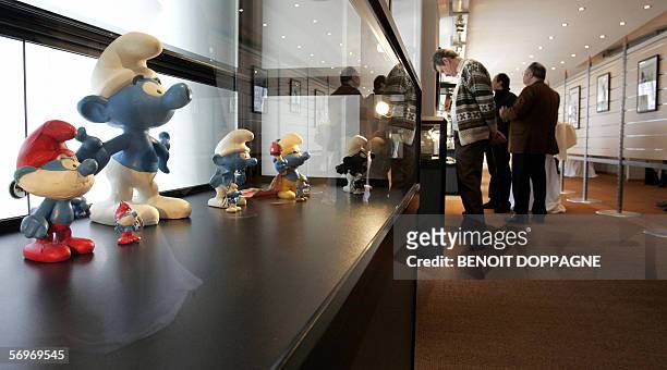 Picture of visitors looking at exhibits near the "smurfs" 01 March 2006 inside the newly opened " Maison de la Bande Dessinee " in Brussels. AFP...